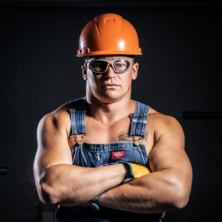 A tradesperson on a job, hands full — the moment a call gets missed